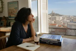 pensive woman in a Marseille kitchen weighing training options, sunlight filtering through window, course catalogs on table, calm and authentic atmosphere